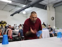 a man standing in front of a table