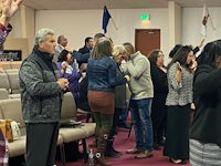 a group of people standing and clapping in a church
