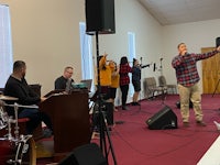 a group of people singing in a church