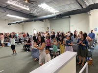 a large group of people standing in a room