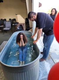 a woman is in a tub of water