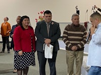 a group of people standing in front of a microphone