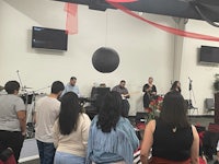 a group of people standing in front of a stage