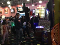 a group of people standing in a game room