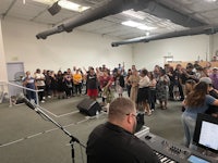 a large group of people standing in a room