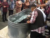 a group of people standing in a tub of water