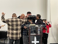 a group of people standing in front of a microphone