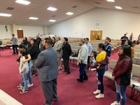 a group of people standing in a church