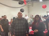 a group of people standing at a table in a room