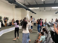 a group of people raising their hands in a church