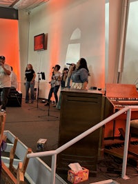 a group of people standing on a stage in a church