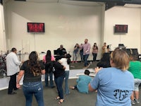 a group of people standing on a stage in a church