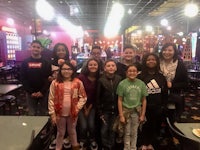 a group of kids posing for a picture in a casino