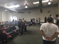 a group of people standing in a church