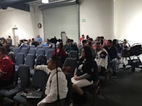 a group of people sitting in chairs in a room