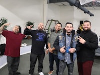a group of men posing for a picture in an office