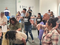 a group of people standing around in a room