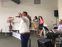 a group of people singing in a church