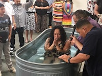 a woman is being baptized in a tub