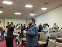 a group of people standing in a church
