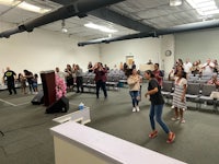 a large group of people standing in a room