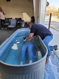 a man is laying in a tub of water