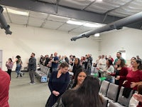a large group of people standing in a room