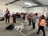 a group of people standing in front of a microphone