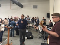 a group of people singing in a church
