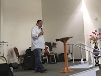 a man standing in front of a microphone