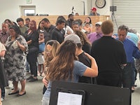 a group of people standing around in a room