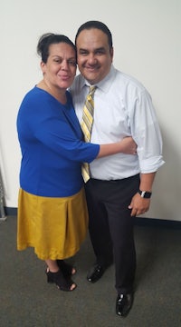 a man and woman hugging in an office