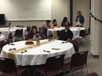 a group of people sitting at tables in a room