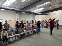 a large group of people standing in a room
