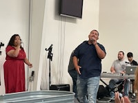 a group of people singing in a room