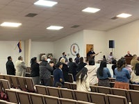 a group of people standing in front of a church