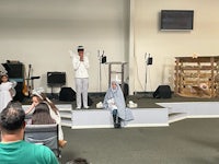 a group of people dressed up in nativity costumes in a church
