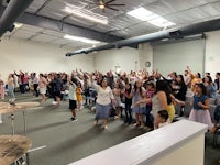 a group of people standing in a room with drums