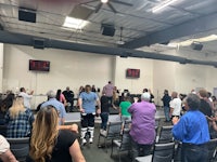 a large group of people standing in a room
