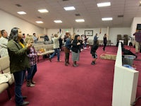 a group of people standing and clapping in a church
