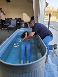 a man is putting a woman in a tub