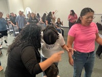 a group of people standing in a room with a child
