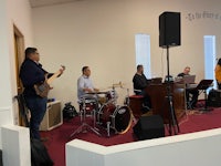 a group of people playing music in a church