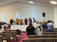 a group of people standing in a church