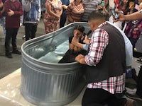 a woman is being baptized in a tub