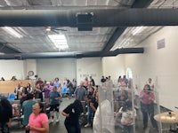 a large group of people standing in a room