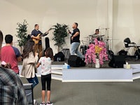 a group of people standing on stage in a church