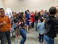 a group of people dancing in a church