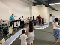 a group of people standing in front of a stage