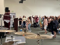 a group of people standing in a room with drums
